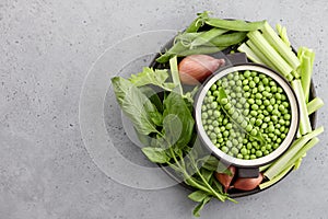 Fresh pea soup ingredients on concrete background