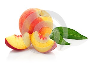 Fresh peach fruits with green leaves