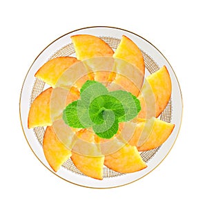 Fresh peach slices and mint herb in plate isolated on white