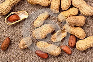 Fresh peanuts in shell on burlap, top view