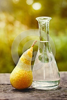 Fresh pear and fruit brandy in bottle