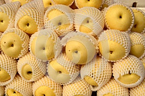 Fresh pear fruit symmetrically to attract buyers at market stall photo