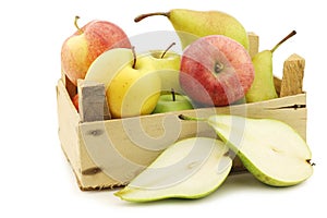 Fresh pears and apples in a wooden crate