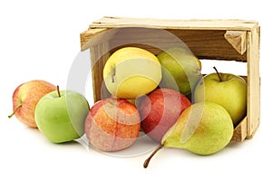 Fresh pears and apples in a wooden crate