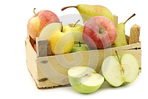 Fresh pears and apples in a wooden crate