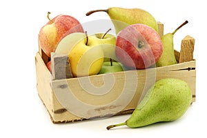 Fresh pears and apples in a wooden crate