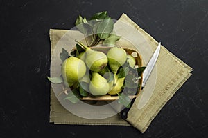 Fresh pears on a dark table.Pears on a wooden background. Fruit harvest. Autumn still life.Top view. Flat lay. Copyspace