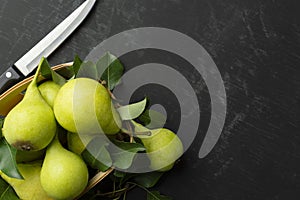 Fresh pears on a dark table.Pears on a wooden background. Fruit harvest. Autumn still life.Top view. Flat lay. Copyspace