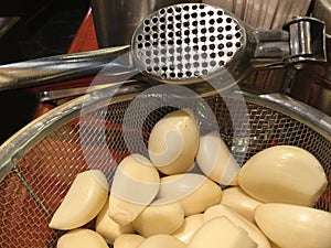 Fresh Peeled Garlic Cloves with a Garlic Press