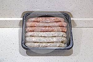 Fresh peppered raw sausages ready for frying