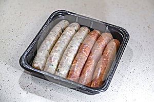 Fresh peppered raw sausages ready for frying