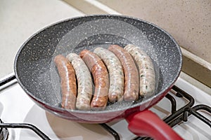 Fresh peppered raw sausages ready for frying