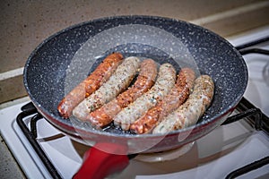 Fresh peppered raw sausages ready for frying