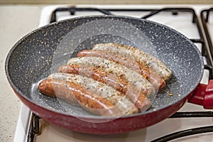 Fresh peppered raw sausages ready for frying