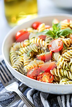 Fresh Pesto Pasta Salad With Cherry Tomatoes and Basil in Natural Daylight