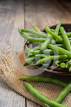 Fresh picked green beans on a wooden table photo