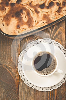 fresh pie and cup of fragrant black coffee/fresh pie and cup of black coffee on a wooden table. Top view