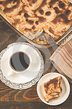 Fresh pie and cup of fragrant black coffee/fresh pie and cup of fragrant black coffee on a wooden background. Top view