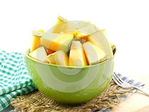 Fresh piece of cantaloupe melon slices on green bolw