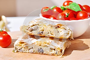 Fresh piece of savory strudel stuffed with chicken meat and mushrooms s