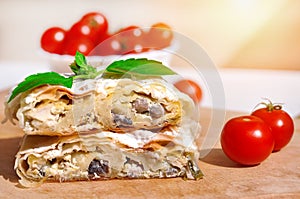 Fresh piece of savory strudel stuffed with chicken meat and mushrooms s