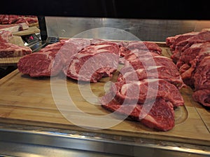 Fresh pieces of meat located on the counter for sale