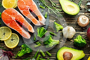 Fresh pieces of salmon steak, trout, salmon, pink salmon. With ingredients vegetables, avocado, rosemary and broccoli. Healthy and