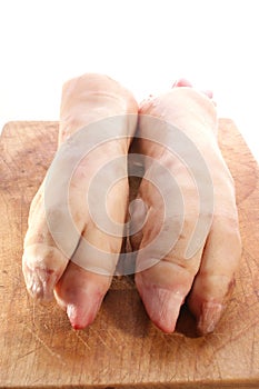 fresh pig trotter on timber board