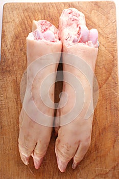 fresh pig trotter on timber board