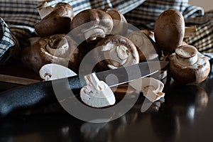 Fresh pile of organic champignon mushrooms isolated from background with clipping knive and full depth of field