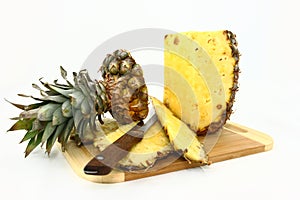 Fresh Pineapple Being Cut On A Wooden Board