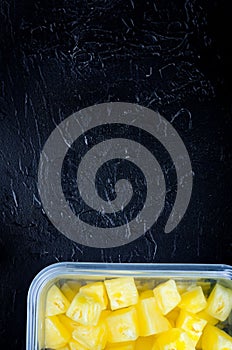 Fresh Pineapple Chunks on Black Background