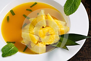 Fresh pineapple dessert recipe with mint orange coulis