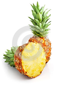 Fresh pineapple fruit with cut and green leaves