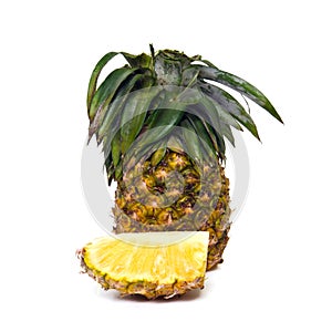 Fresh pineapple fruit with sliced pieces isolated on white