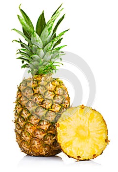 Fresh pineapple fruits with cut and green leaves isolated on white
