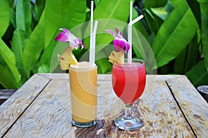 Fresh Pineapple Juice Shake frappe and Cocktail strawberry punch in glass cup serve to customer guest travelers eat drink at