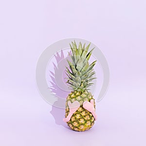 Fresh pineapple like wise monkey. Concept of see no evil. Summer fruit on pastel purple background