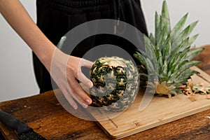 Fresh pineapple preparation on a wooden cutting board