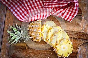 fresh pineapple tropical fruits summer, pineapple slice on plate for food fruit ripe pineapple on wooden background - top view