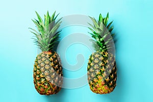 Fresh pineapples on blue background. Top View. Pop art design, creative concept. Copy Space. Bright pineapple pattern
