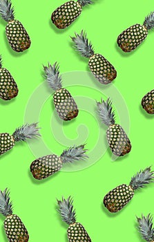 Fresh pineapples on the green colorfurful background