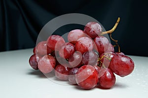 Fresh pink bunch of grapes on a white background