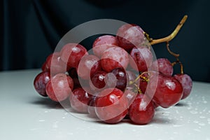 Fresh pink bunch of grapes on a white background