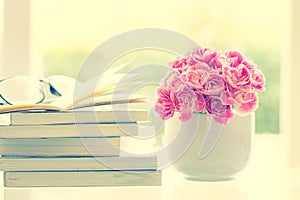 Fresh pink carnation flower with books background