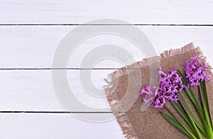 Fresh pink flowers hyacinths on white wooden table. Top view, copy space.