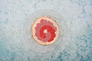 Fresh pink grapefruit slice over crushed ice