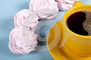 Fresh pink homemade zephyr - marshmallow and cup of coffee on bl