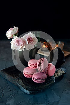 Fresh pink macaroni macarooni cookies on a wooden Board. Sweet homemade cakes. copy space