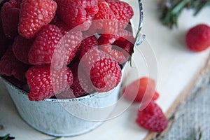 Fresh pink raspberry in a small bucket